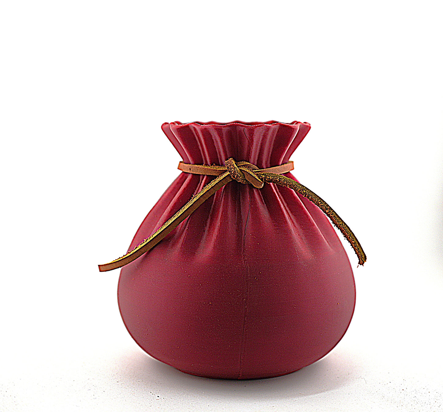Small matte red drawstring pouch‑style vase with a brown leather cord, photographed against a clean white background.