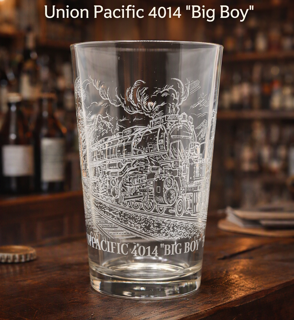 Engraved Union Pacific Big Boy 4014 pint glass on a rustic wooden bar counter, featuring detailed steam locomotive etching and warm vintage lighting.