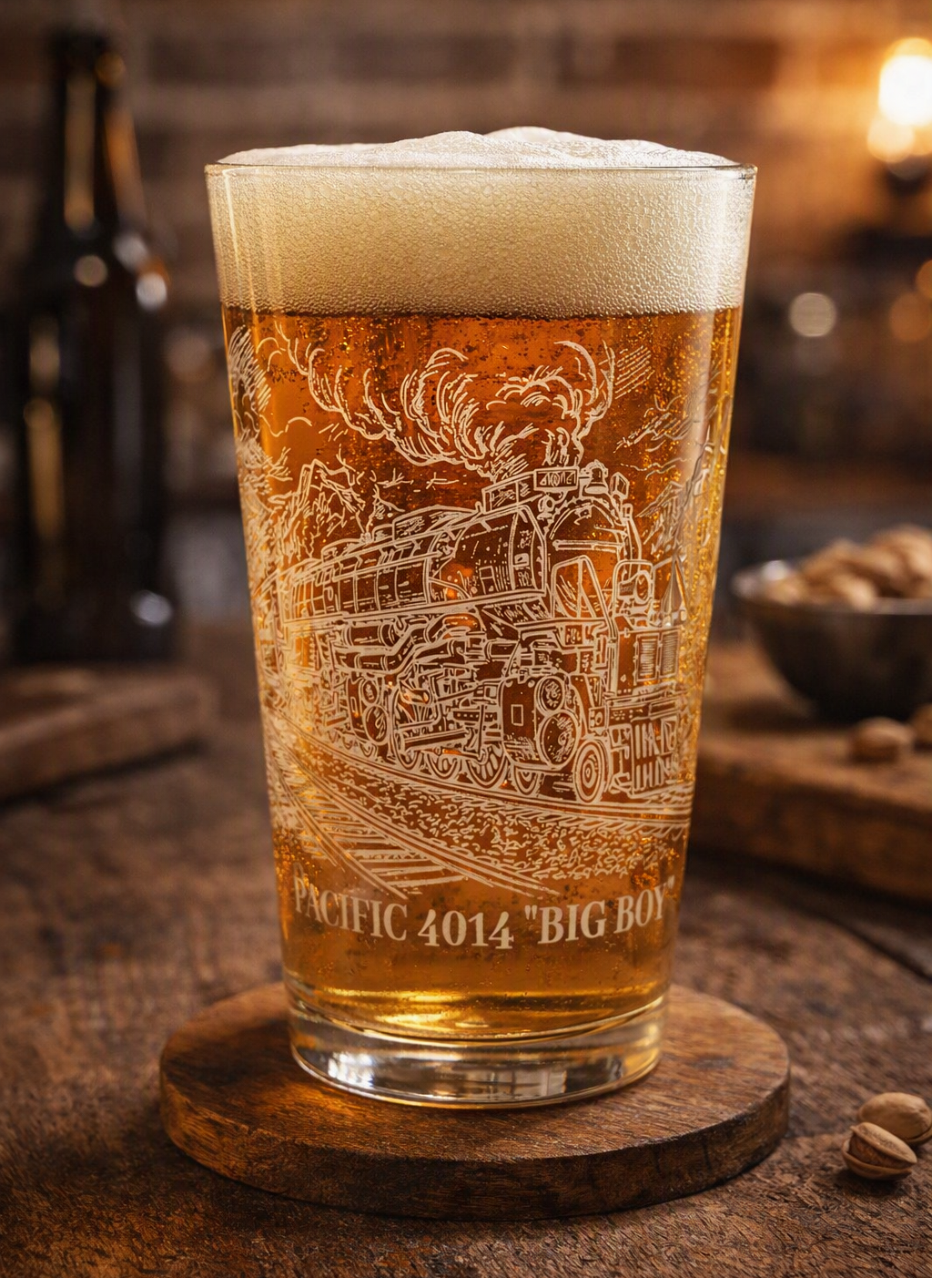 Engraved Union Pacific Big Boy 4014 pint glass filled with amber beer on a rustic wooden bar counter, featuring detailed steam locomotive etching and warm vintage lighting.