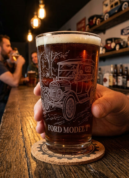 Hand holding a 16 oz Ford Model T engraved beer pint glass filled with dark beer at a rustic bar.