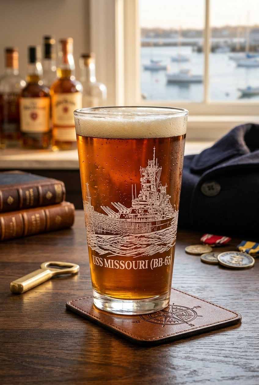 Engraved USS MISSOURI (BB-63) beer glass filled with amber brew in a home bar setting.
