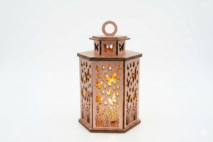 handcrafted wooden butterfly lantern made of wood-composite with a rose-gold or coppery finish, featuring intricate laser-cut patterns of butterflies and meadow grass, illuminated from within by a warm, glowing light on a plain white background
